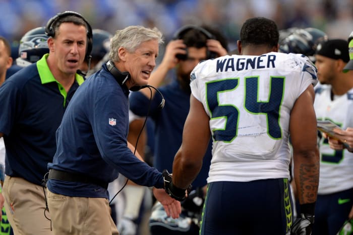 Seattle Seahawks head coach Pete Carroll talks to middle linebacker Bobby Wagner (54) after they stopped Baltimore Ravens on fourth down during the second half at M&T Bank Stadium. Seattle Seahawks defeated Baltimore Ravens 35-6.